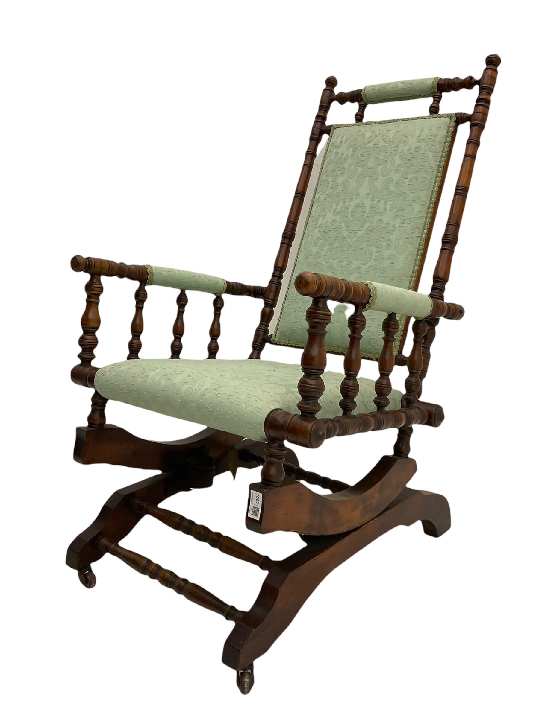 Early 20th century walnut framed American rocking chair, upholstered seat, back and arms