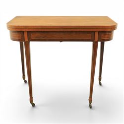 Regency mahogany fold-over tea table, rounded rectangular top with gateleg action, inlaid and crossbanded frieze, raised on squared tapering supports on brass castors
