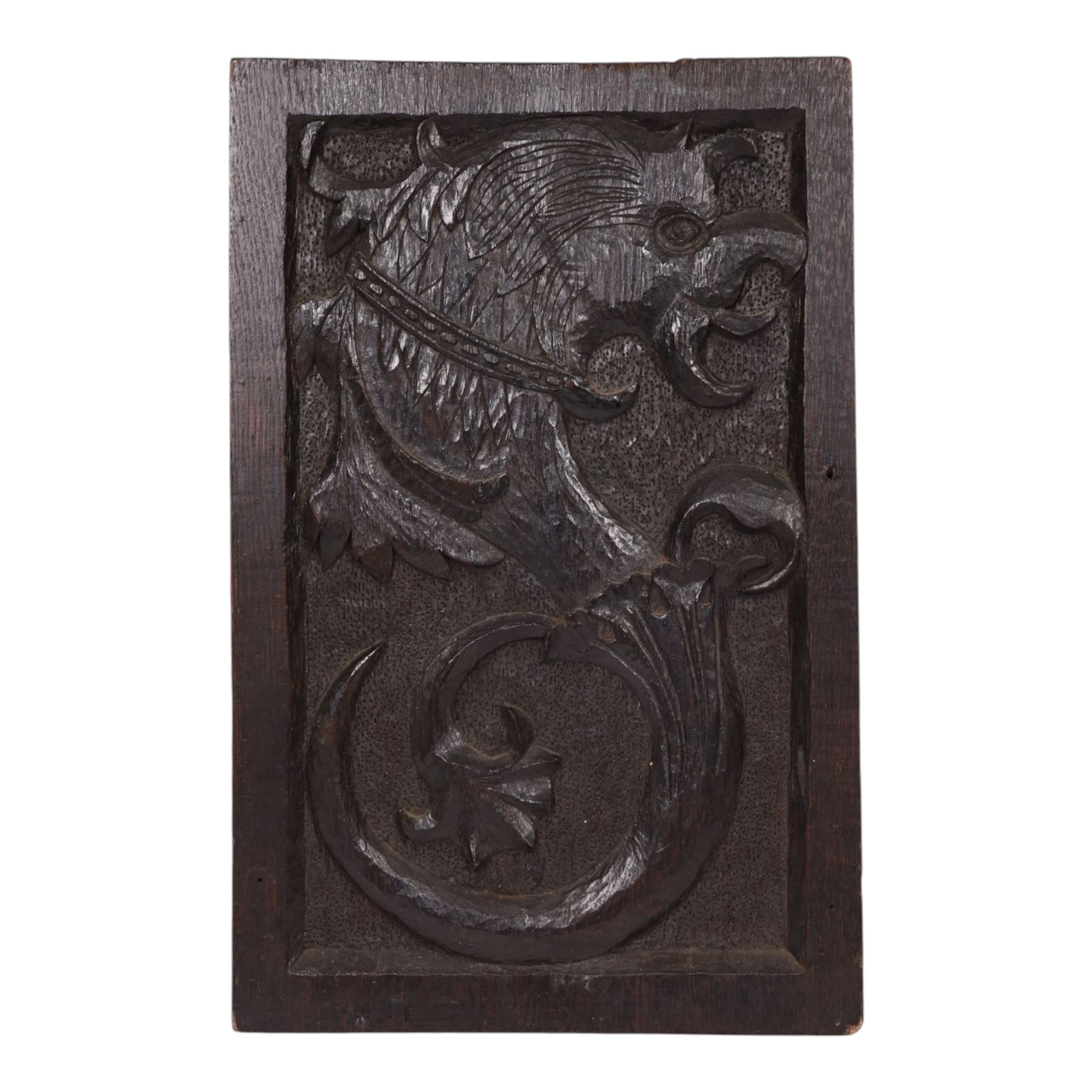 19th century oak panel, the center carved with a mythical creature 