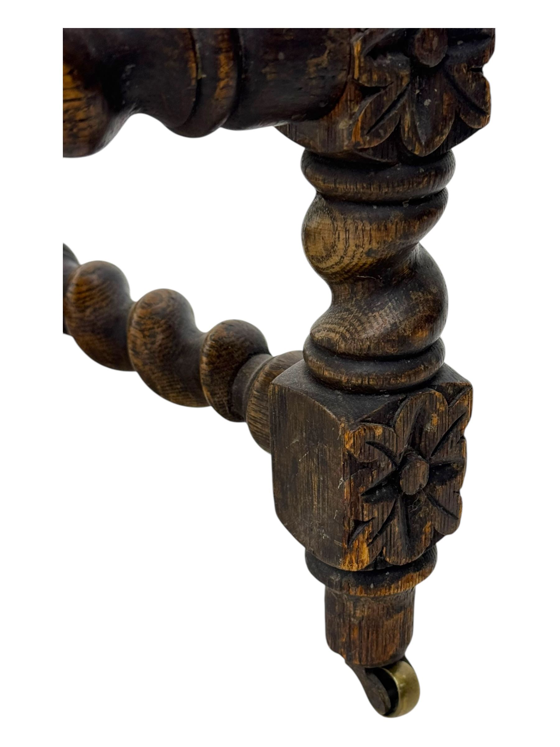 19th century Carolean design oak armchair, upholstered in a vibrant fabric depicting woodland and wildlife scenes, carved lion mask arm terminals, raised on barley twist supports united by H-stretcher