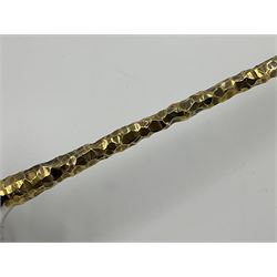 Pair of modern silver candlesticks by Stuart Devlin, the tapering parcel gilt stems with signature textured detailing, each supporting a fluted candle holder and upon a spreading circular foot, hallmarked Stuart Devlin, London 1973, H25cm