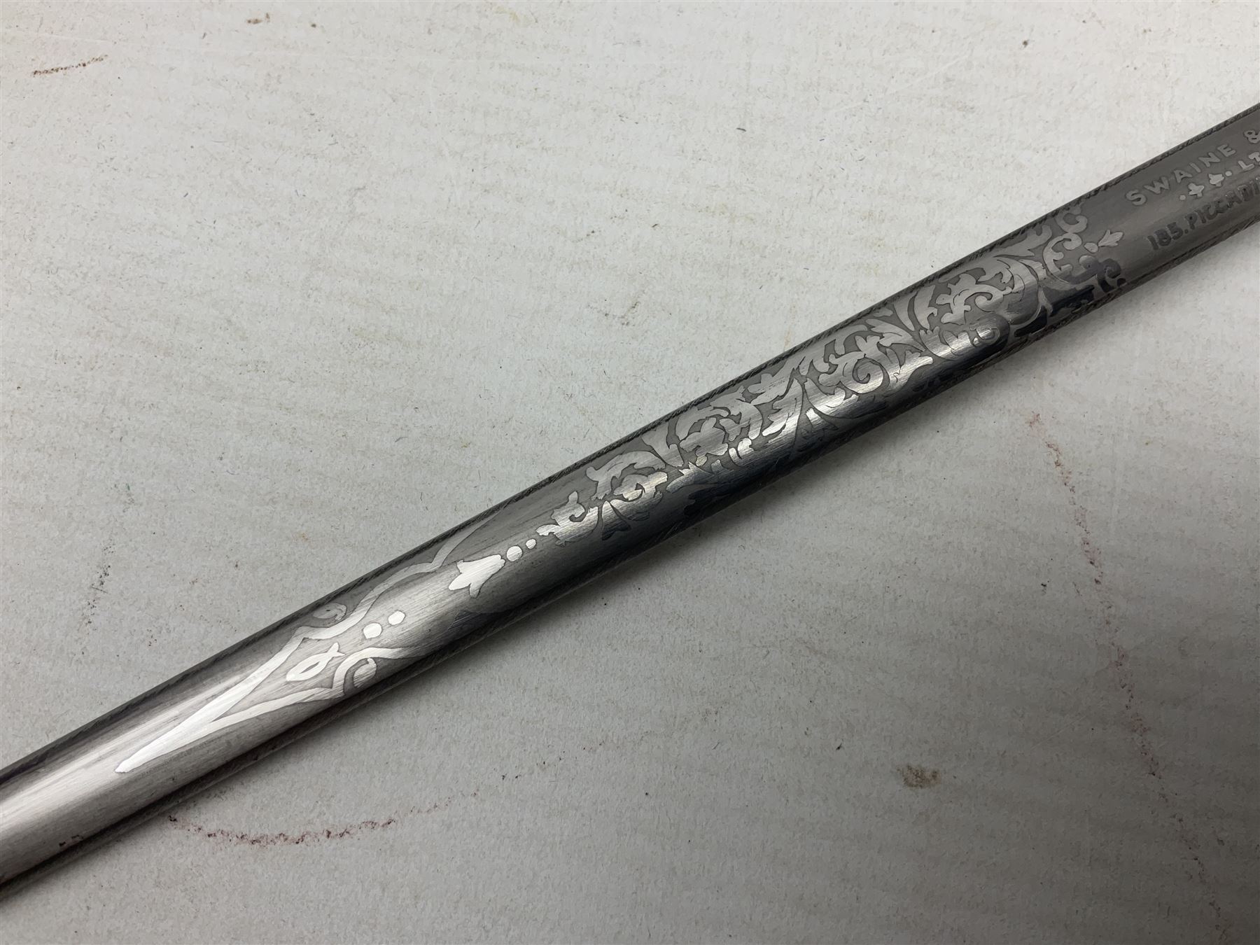 Early 20th century British Army Officer’s leather covered swagger / sword stick by Swaine & Adeney of 185 Piccadilly London; 34.5cm double edged spear point blade with etched foliate decoration and retailer’s details; stamped 'Forged in London' to the edge of the ricasso; L59.5cm overall