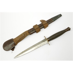British Fairbairn-Sykes type 3rd pattern Commando fighting knife with unmarked 17cm double edged blade, oval brass cross-guard and ringed grip, in brown leather scabbard 32cm overall