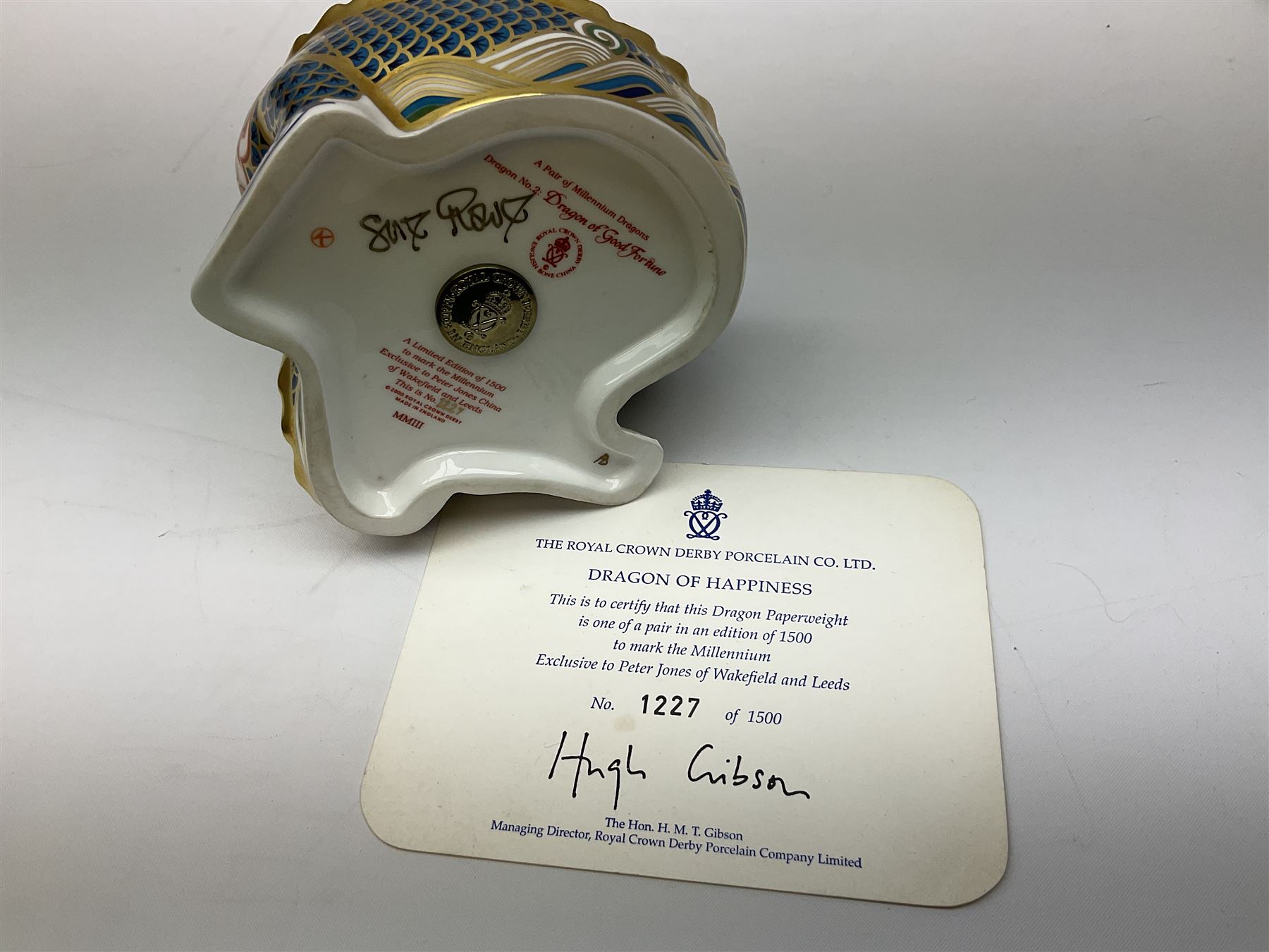 Two Royal Crown Derby paperweights, Dragon of Happiness, limited edition 1227/1500 and Dragon of Good Fortune, limited edition 1227/1500, both with gold stopper, hardwood base, certificate and with printed mark beneath