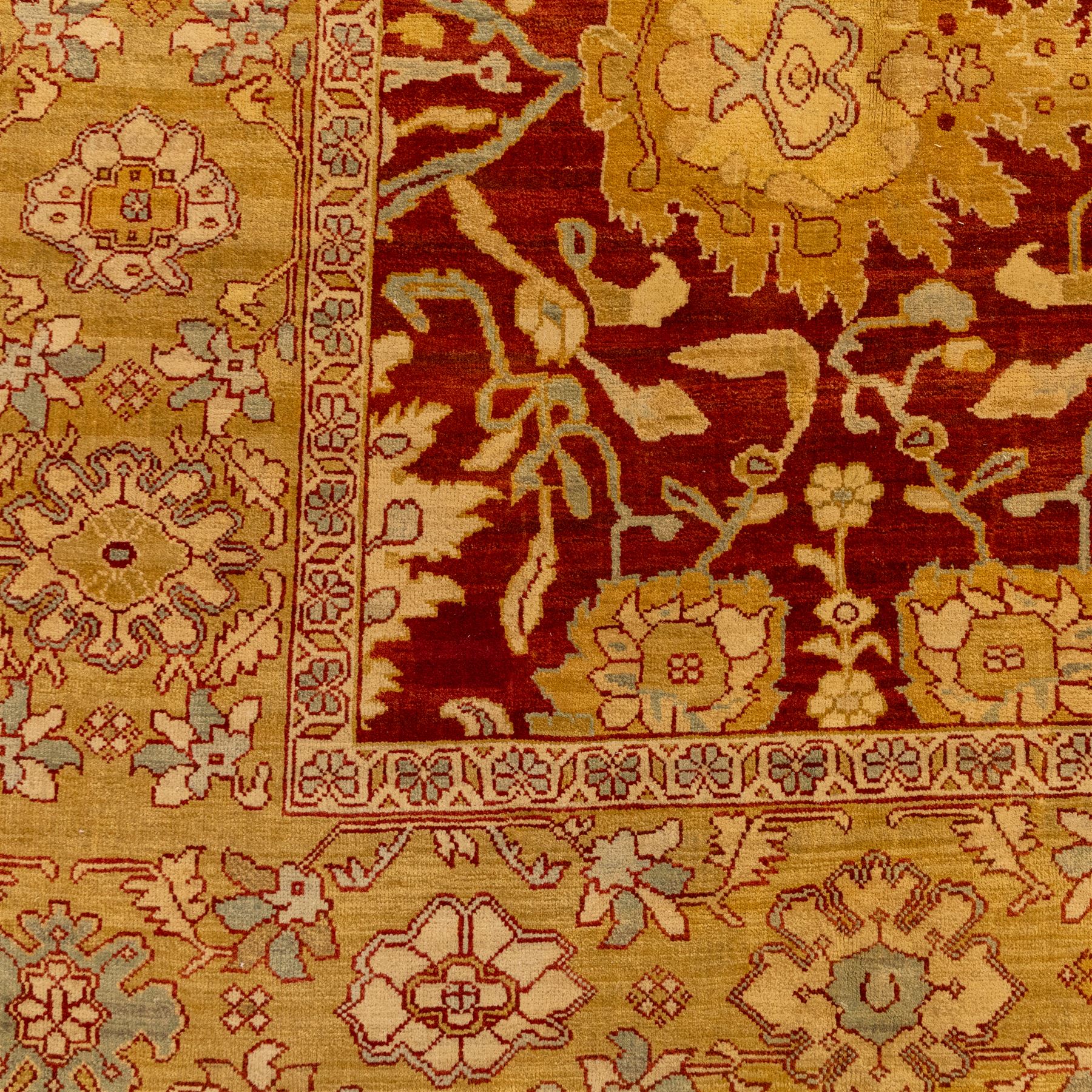 Central Persian Ziegler design hand-woven carpet, rich madder red field with central stylized lozenge medallion enclosed with an all-over lattice of scrolling vine, palmettes, and angular floral motifs of the Sultanbad tradition, broad ivory main border decorated with large-scale rosettes and flowering cartouches, flanked by narrow guard stripes, with fringe ends 