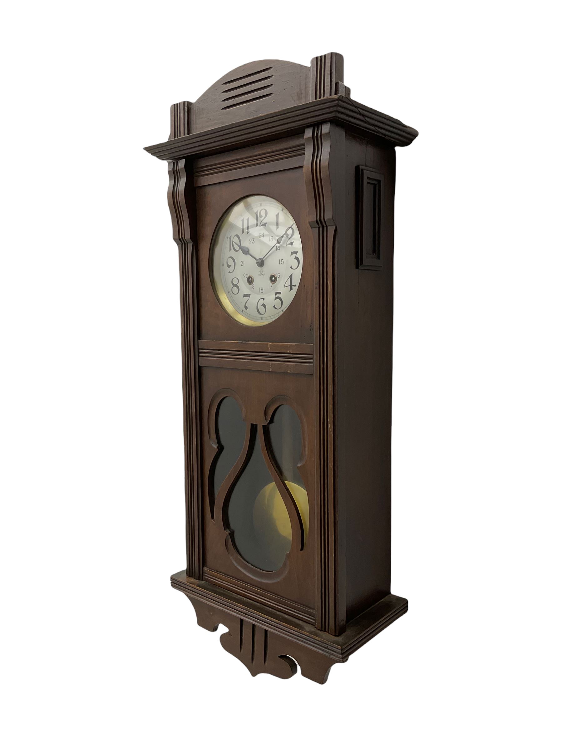 An early 20th century Art nouveau style wall clock with a French countwheel movement by Japy Freres, Paris, in an oak case with a shaped pediment, reeded mouldings and glazed panels, 7” silvered dial with a gilt slip and continental 24-hour Arabic numerals, minute track and steel spade hands, visible pendulum with a brass bob beneath, eight-day spring driven striking movement striking the hours and half-hours on a single gong rod. Movement and dial both stamped with the Japy Feres trademark.




