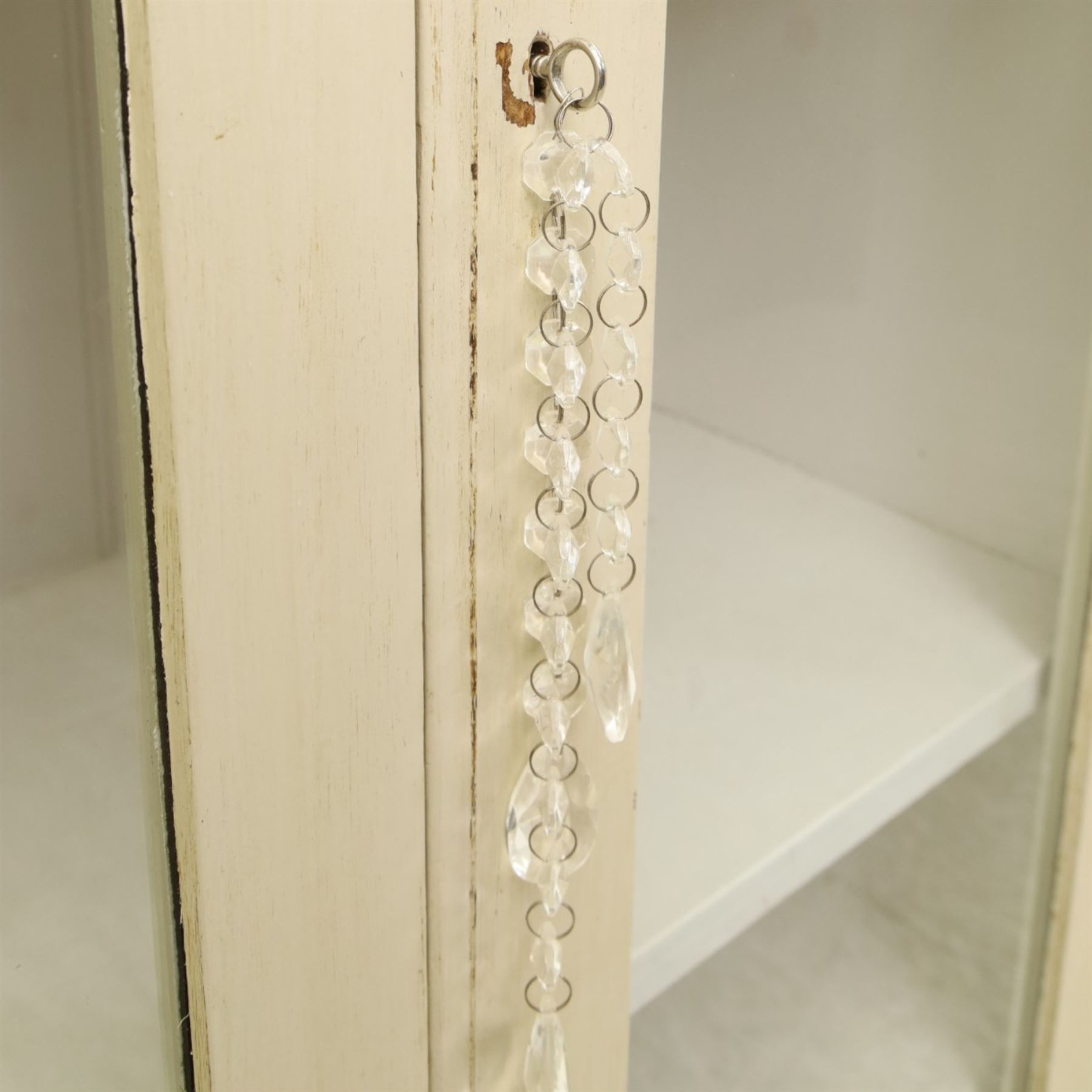 Traditional white painted pine display cabinet, projecting cornice above two glazed doors enclosing five fixed shelves, tongue and groove back raised on a plinth base