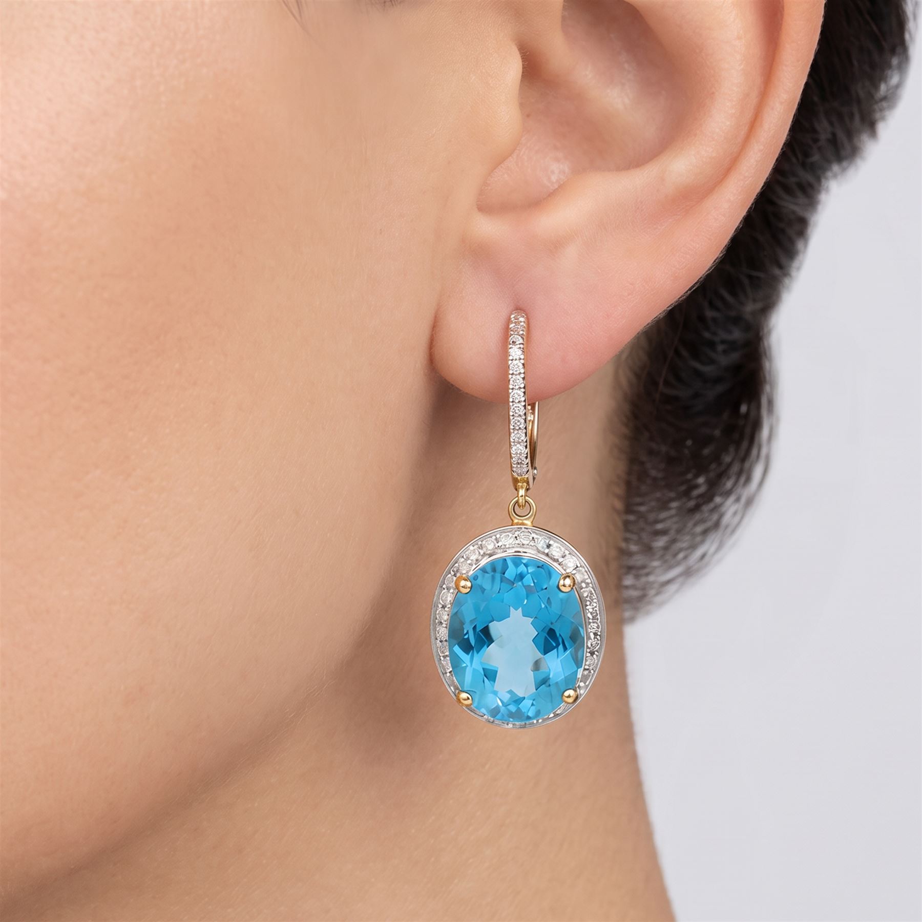 Pair of 14ct gold Swiss blue topaz and diamond pendant earrings, each stud suspending a single oval cut topaz, surrounded by single cut diamonds, to a diamond set bail, total topaz weight approx 8.00 carat