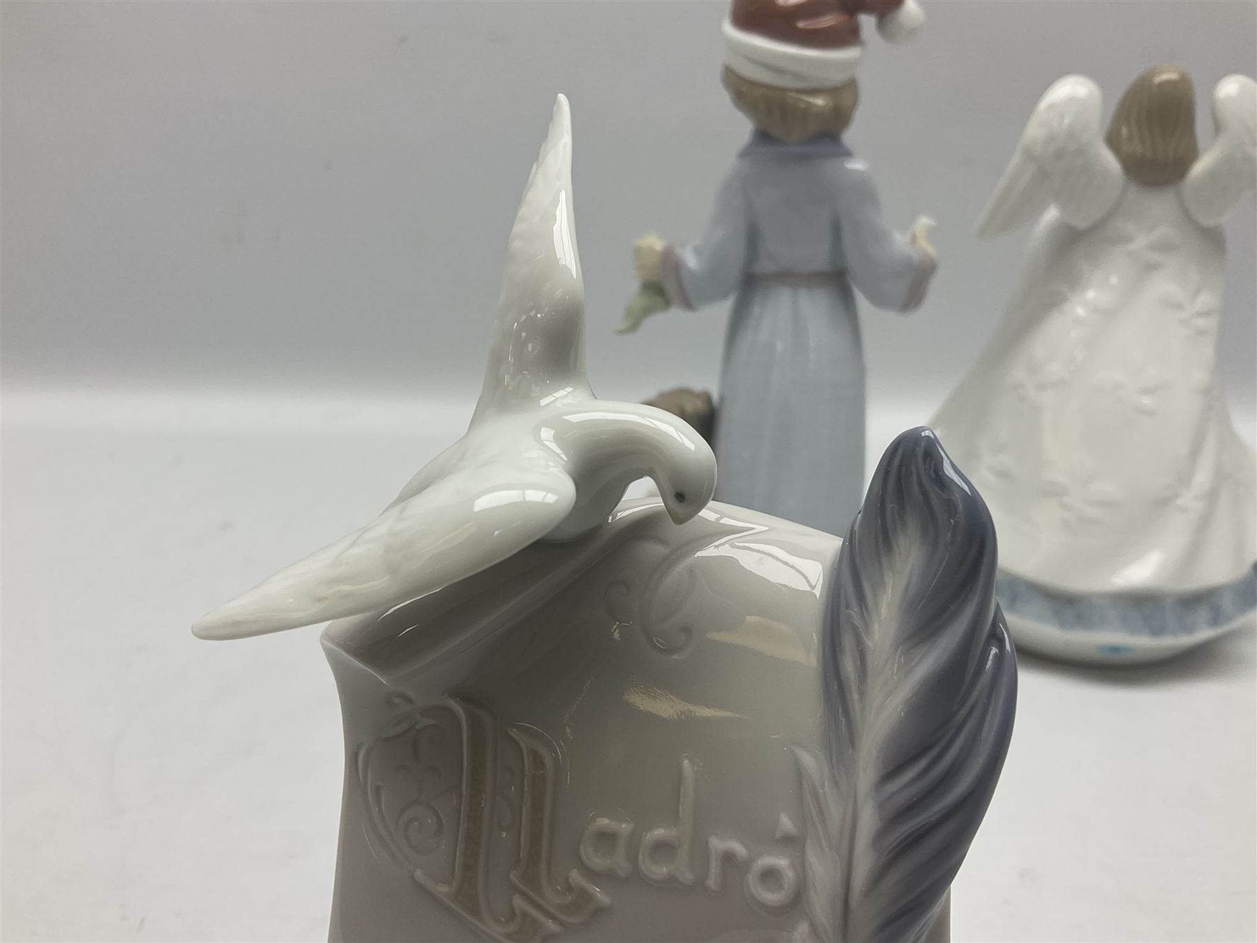 Three Lladro figures, comprising Dear Santa no 6166, Angelic Melody 1993 no 5963 and Seraphs Head no2 no 4885, together with Lladro plaque Love Brings Us Together no 7677, all with original boxes, largest example H18cm