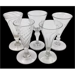Five late 18th/early 19th century short ale drinking glasses, comprising three with wrythen twist trumpet bowls upon short knopped stems and circular feet, slice cut example with bucket bowl raised upon inverted baluster stem and further slice cut example with trumpet bowl upon stem with medial ball knop, tallest H12cm