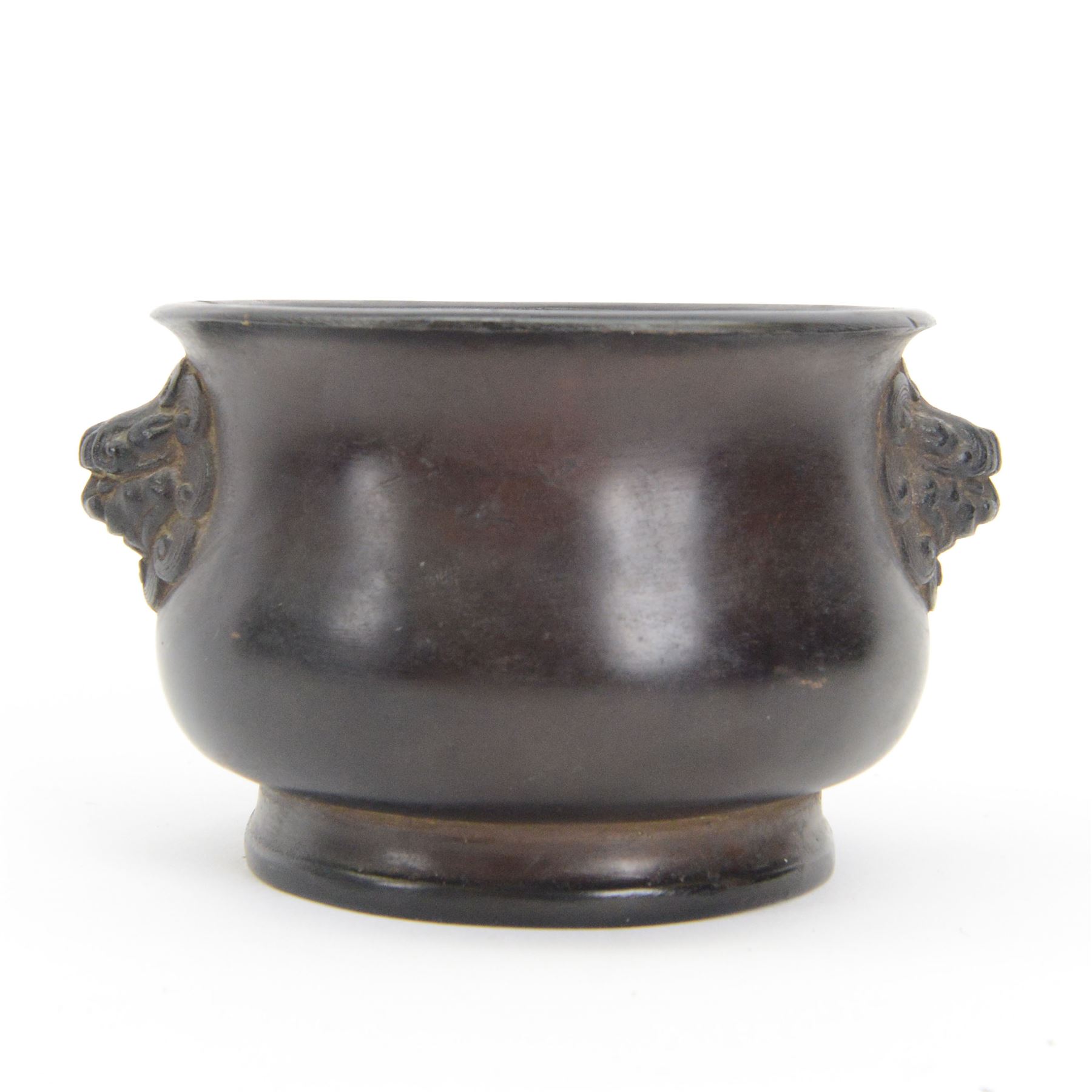 Chinese bronze censer, of circular bellied form with temple lion mask handles, upon a circular foot, with apocryphal six character Xuande mark within a border of two dragons chasing a pearl, H7.5cm D10/5cm
