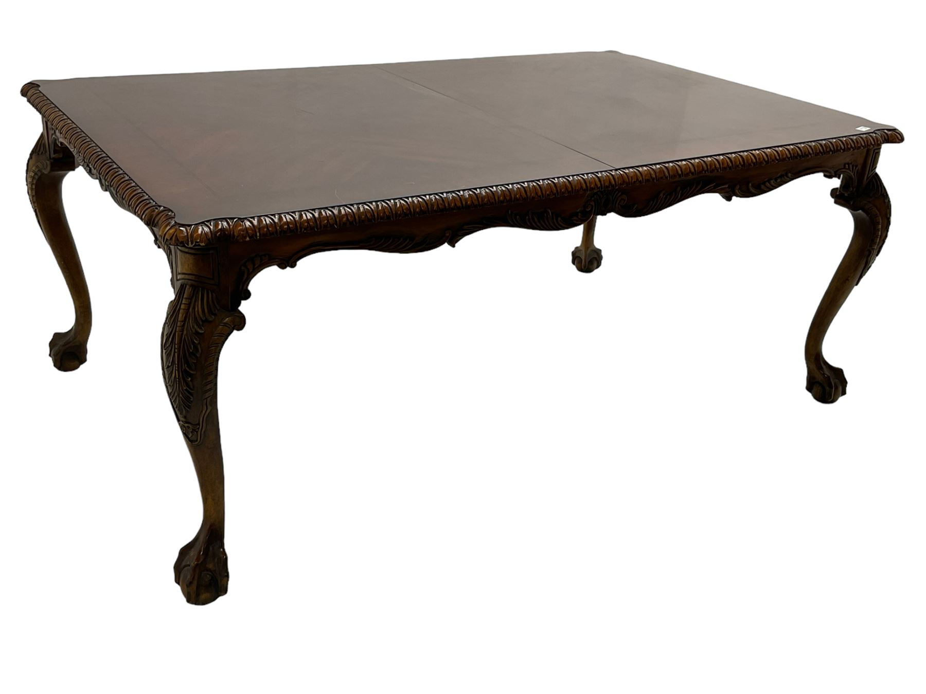 Chippendale Revival - hardwood extending dining table, rectangular gadroon carved top, on acanthus carved cabriole supports with ball and claw feet, with two additional leaves; together with a set of eight (6+2) dining chairs, shaped cresting rail over pierced and carved splat, upholstered drop-in seat, on acanthus carved cabriole supports with ball and claw feet