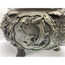 Large Japanese Meiji period bronze jardiniere, cast in high relief with panels depicting birds perched and flying around flowering prunus branches, beneath a border of cranes in a cloudy sky, with three supports, D36cm, H28cm  