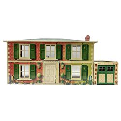 Mid-20th century Mettoy tin-plate double-fronted two-storey doll's house, the front elevation with five unglazed windows flanked by green shutters, central opening door, open back giving access to five rooms together with an attached garage, 60cm wide