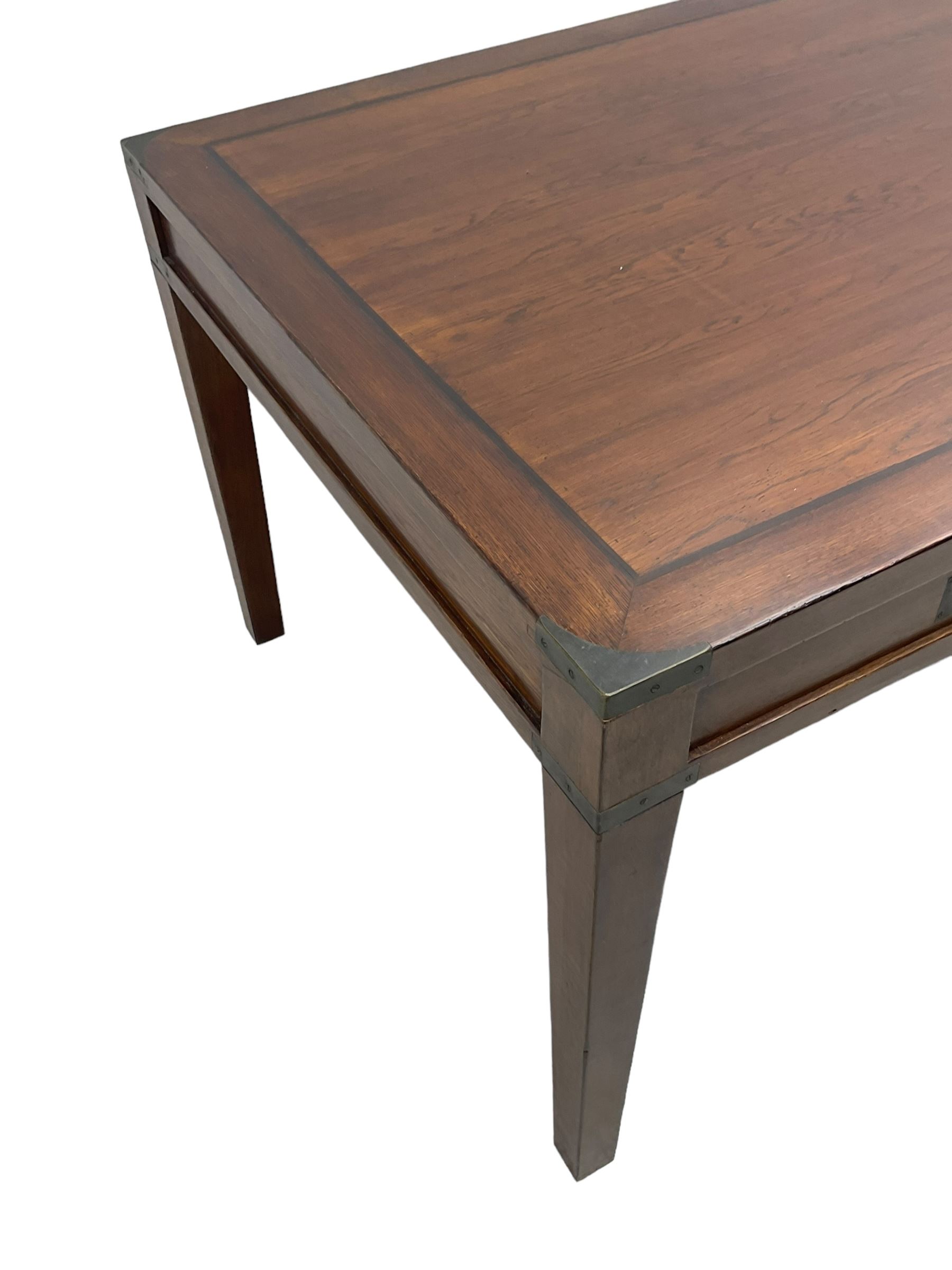 20th century military campaign design oak office or dining table, rectangular top with ebony banding and metal mounted corners, fitted with six drawers with recessed handle plates, on square tapering supports