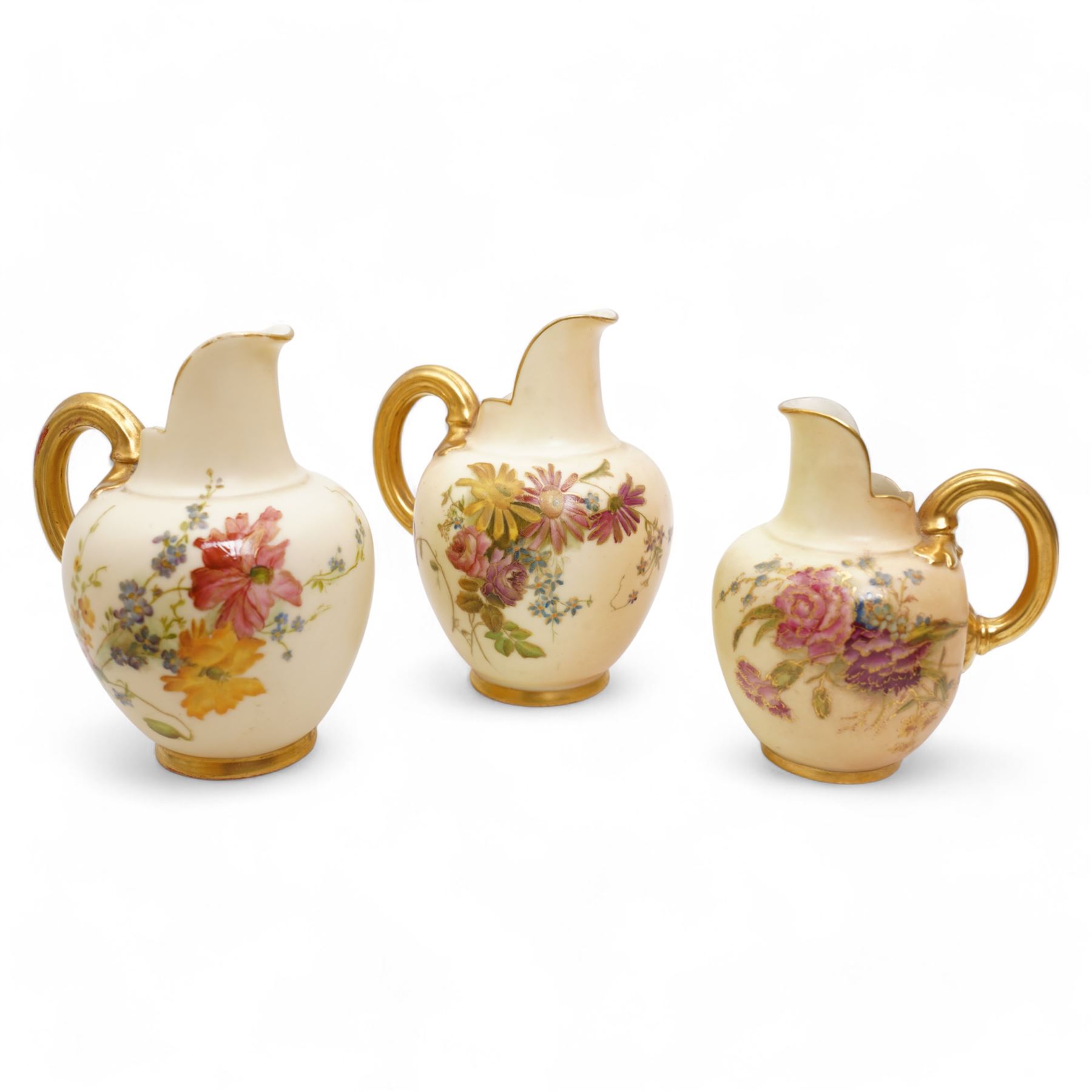 Royal Worcester blush ivory porcelain to include a pair of jugs, no. 1094, pair of vases, no. 1021, and a small ewer no. 1094 (5)