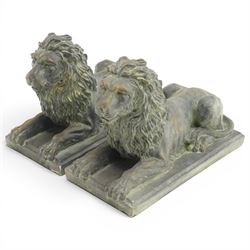 Pair of bronze-effect composition stone recumbent lions, with verdigris-style weathered fi...
