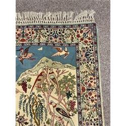 Fine Persian tree of life rug wall hanging, ivory ground field depicting landscape filled with animals, birds and flowers, the guarded border with stylised flower heads and foliage decoration, with brass hanging rail