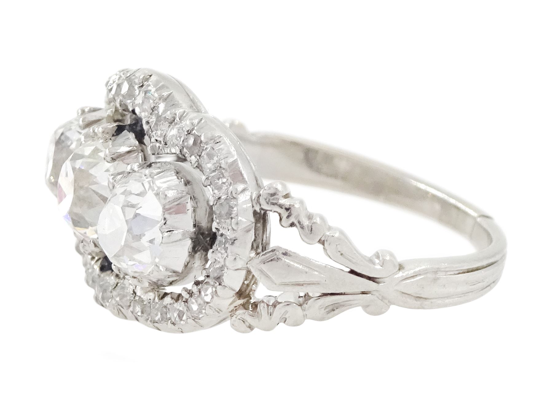 Late 19th / early 20th century platinum diamond ring, three old cut diamonds, in an openwork setting surrounded by further old cut diamonds, with pierced design shoulders, principal three diamonds total weight approx 1.45 carat, in a velvet and silk lined box by Selfridges