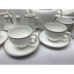 Wedgwood tea, coffee and dinner service for eight, comprising teapot, coffee pot, salt and pepper shakers, two milk jugs and sugar bowls, larger jug, teacups and saucers, coffee cans and saucers, dinner plates, dessert plates, side plates, oval plates, small bowls and larger bowls, all decorated with gilt rim on a white ground, with printed mark beneath (89)