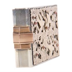 Mid 20th century French silver and gold vanity case, of rectangular form, the hinged cover decorated with an openwork panel of bids and cabochon ruby studded flower heads, opening via a pull clasp to reveal a mirror to the underside and compartment with lift up cover, signed J. Lacloche Paris Cannes, and bearing French assay marks, not including clasp L10cm W6cm D1.5cm

