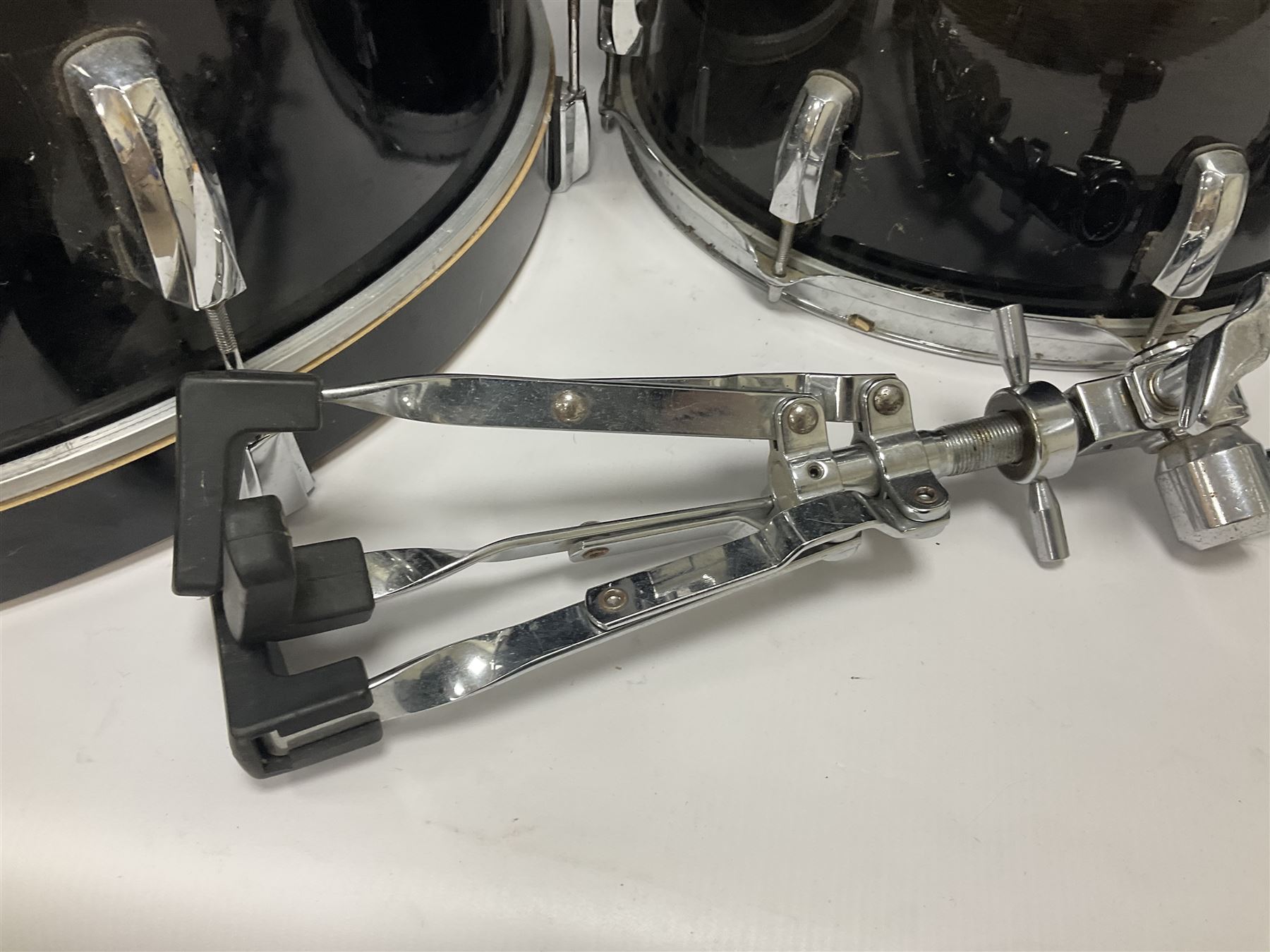 Pearl Vision SST Birch Ply shell four-piece drum kit in black comprising bass drum with foot pedal and three graduated toms; together with Pearl Custom Alloy Sensitone steel snare drum, drum and cymbal stands, microphone stand, stool and various drum sticks 