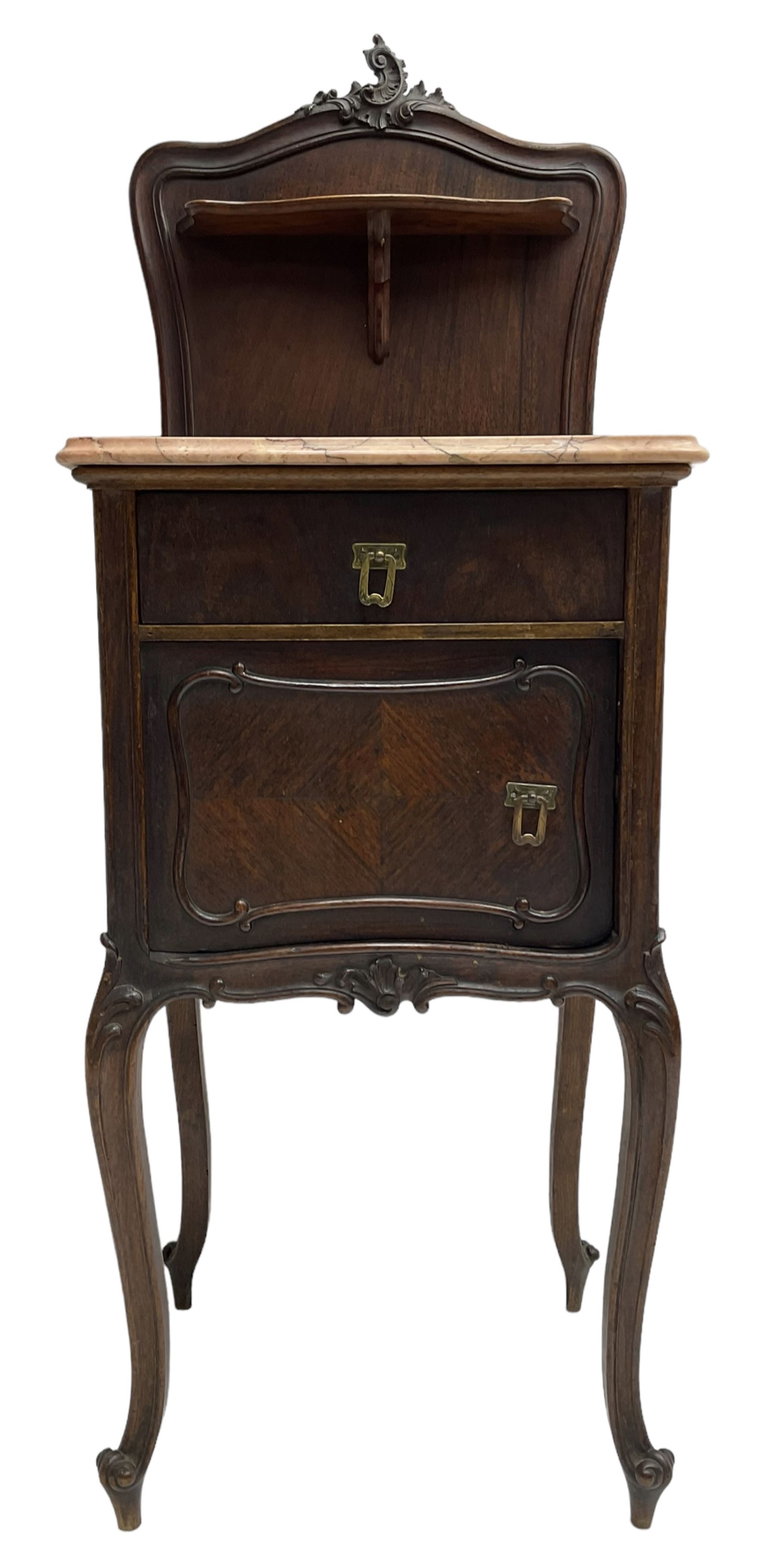 Late 19th to early 20th century walnut bedside pot cupboard, the shaped raised back with carved C-scroll pediment, pink variegated marble top, fitted with single drawer and cupboard, foliage carved cabriole supports with scroll carved terminals