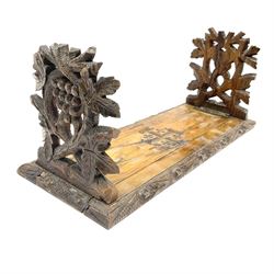 An olive wood book trough, the hinged ends carved as fruiting vines, with slide mechanism, not extended L36cm, extended L57.5cm