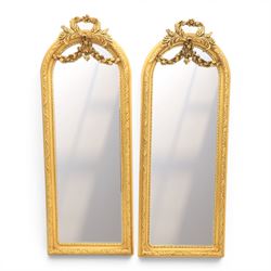 Louis XVI style giltwood pair of wall mirrors, arched frames with moulded borders, surmoun...
