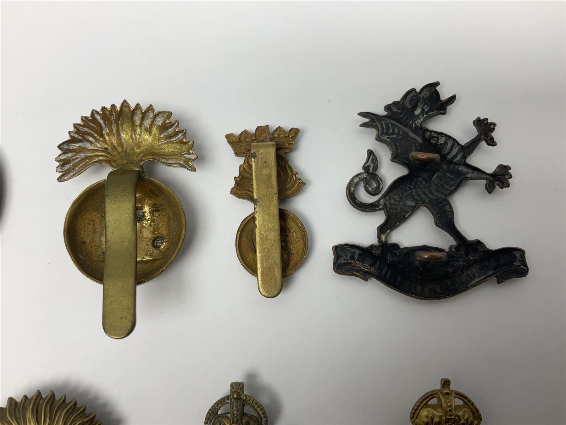 Fourteen cap badges of Irish interest including Royal Dublin Fusiliers inscribed to the slider 'From A. O'Connor 2nd Batt. Dec.2nd 1915', Connaught Rangers, South irish Horse Yeomanry, Inniskilling Fusiliers, Royal Irish Regiment etc; and seven Welsh badges including South Wales Borderers, Welsh Guards, 3rd Bn. Monmouthshire Regt. etc (21)