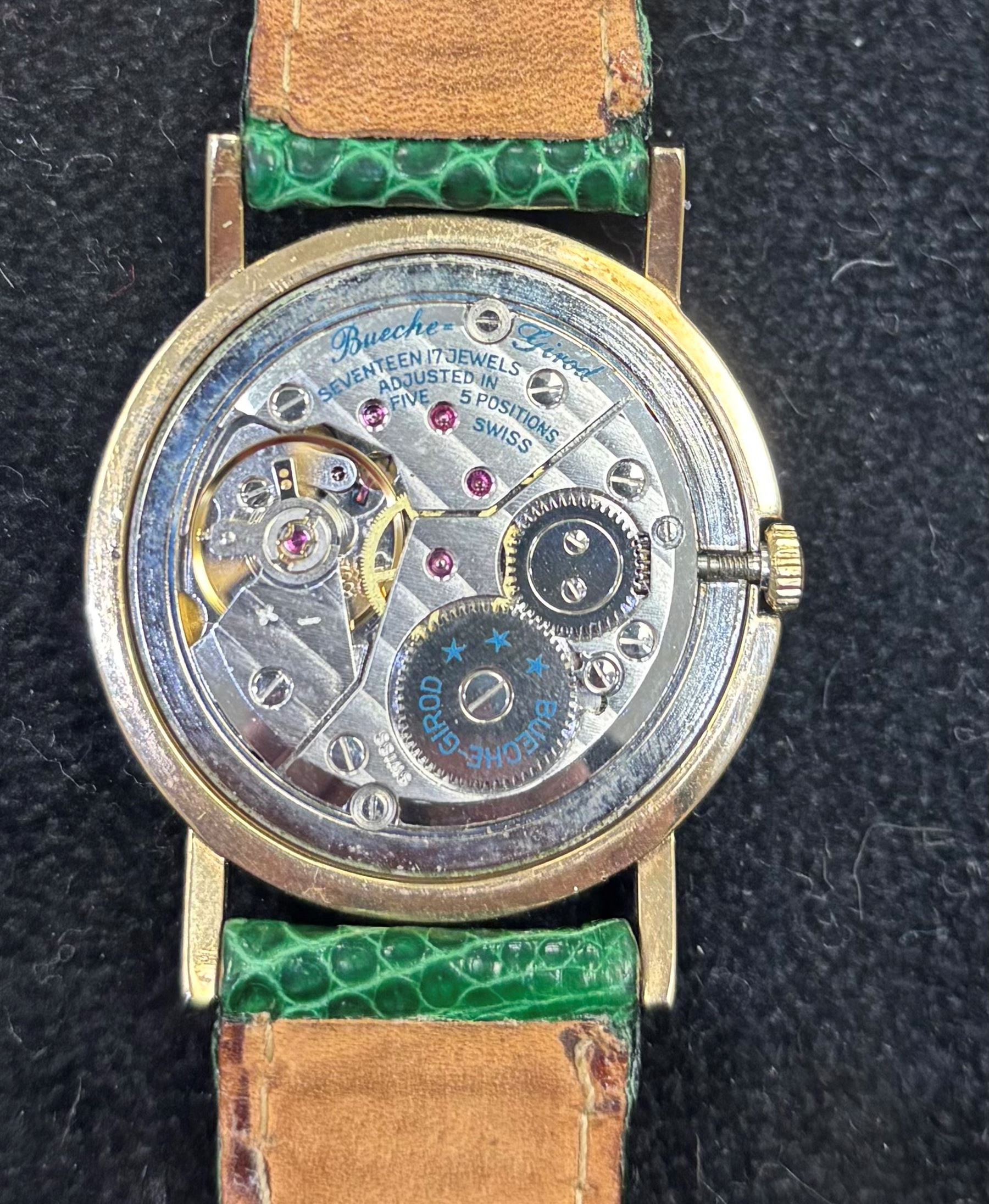 Bueche-Girod 9ct gold, manual wind wristwatch, white dial with Roman numeral hour markers, London 1977, on green leather strap