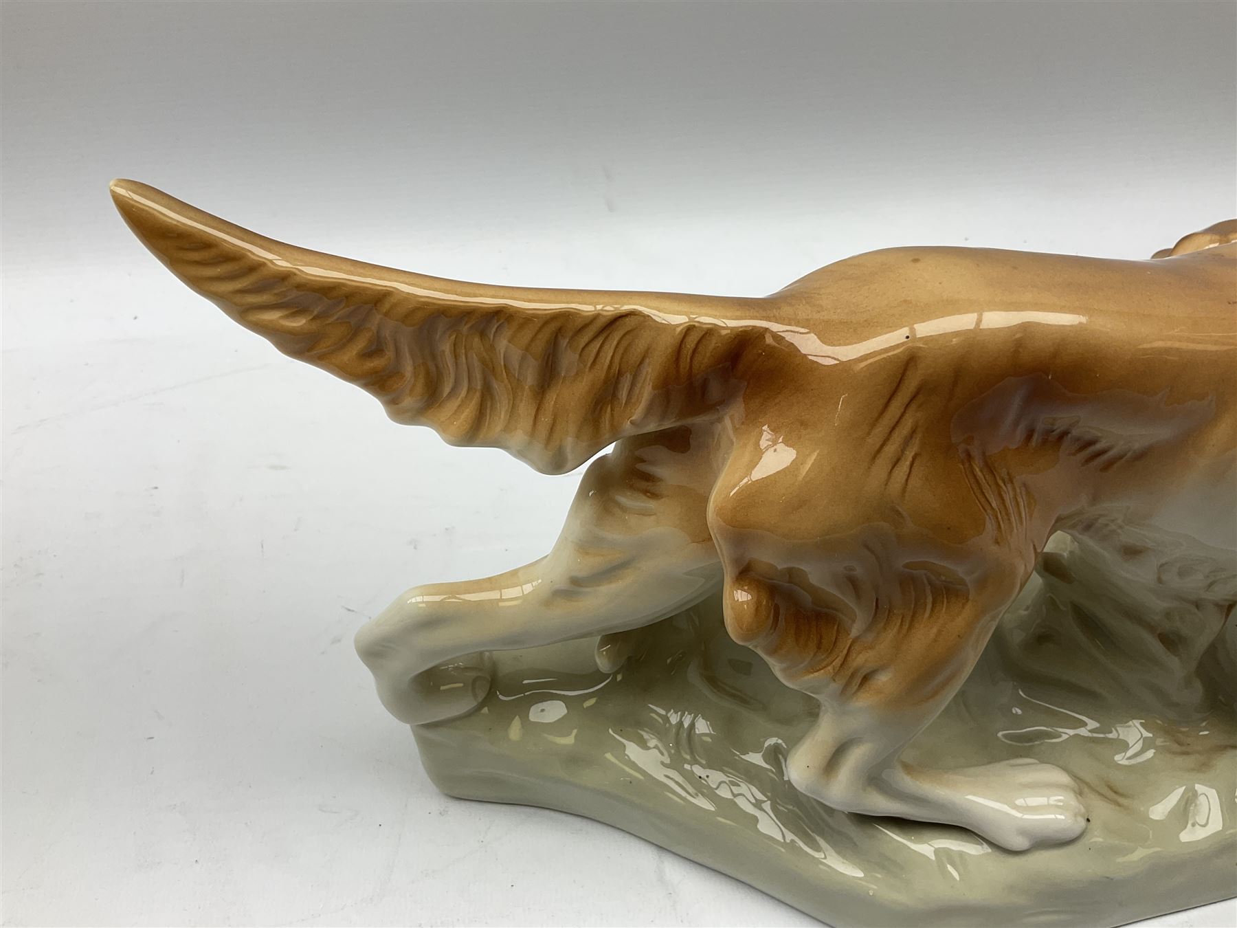 Royal Dux porcelain hunting dog with a bird, printed mark beneath, L36cm