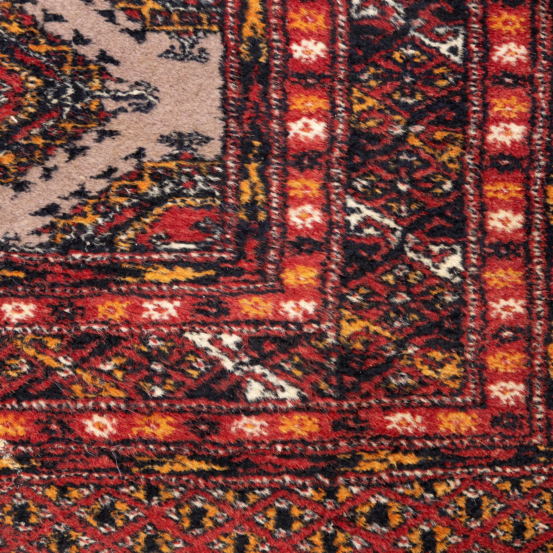 Tekke Bokhara hand knotted  runner, crimson field decorated with a series of repeating Tekke gul motifs arranged in rows within narrow geometric borders with chevron and diamond devices, 78x248cm 