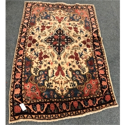  Persian style beige ground rug, central medallion, repeating border (169cm x 105cm) and a red ground rug (W169cm x 122cm) (2)  