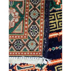 Small Persian indigo ground rug, the field decorated with Gilt motifs with trailing bead and stylised foliage, emerald green ground border decorated with geometric design and flower heads