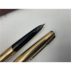 Three rolled gold Parker fountain pens, comprising an example with a gold nib marked 14K 585 and barrel with a shell stamp, a Parker 61 fountain pen with inset gold arrow to the nib, and another similar, all with striated decoration and arrow clips to the caps, L13cm, one with box