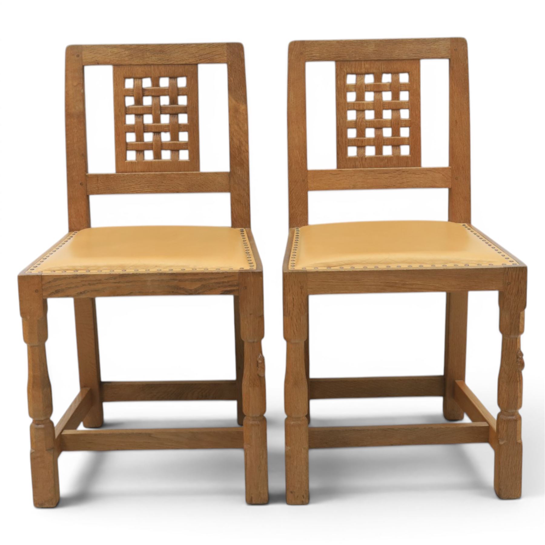 Mouseman - set of four oak lattice back chairs with tan seat with brass studded trim, with carved mouse signature, by the workshop of Robert Thompson of Kilburn