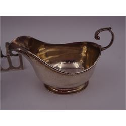 1920s silver sauce boat, with flying C scroll handle and upon oval foot, hallmarked Collingwood & Sons Ltd, Birmingham 1925, together with a mid 20th century silver sugar caster, of typical form, hallmarked Viner's Ltd, Sheffield 1958 and two small silver five bar toast racks, one hallmarked Poston Products Ltd, Birmingham  1960, the other hallmarked Viner's Ltd, Sheffield 1963, caster H18cm