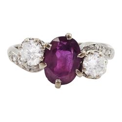 18ct white gold three stone oval ruby and round brilliant cut diamond ring, with diamond set shoulders, stamped, ruby approx 1.15 carat, total diamond weight approx 0.55 carat, in silver top ring box by The Victorian Ring Box Co, Edinburgh 1993 