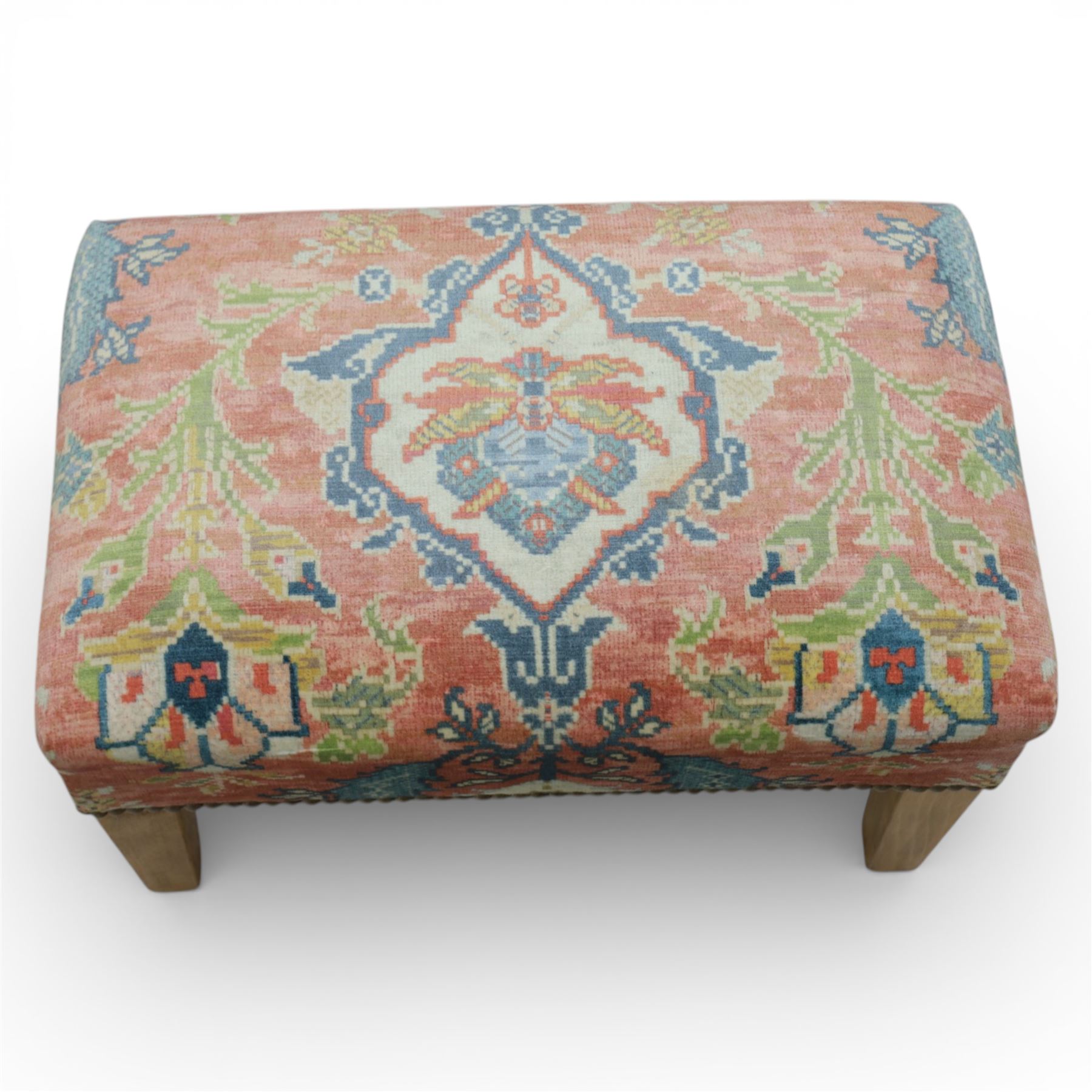 Pair of needlepoint footstools, retailed by The Bespoke Footstool Co, brass studded trim on tapered oak supports