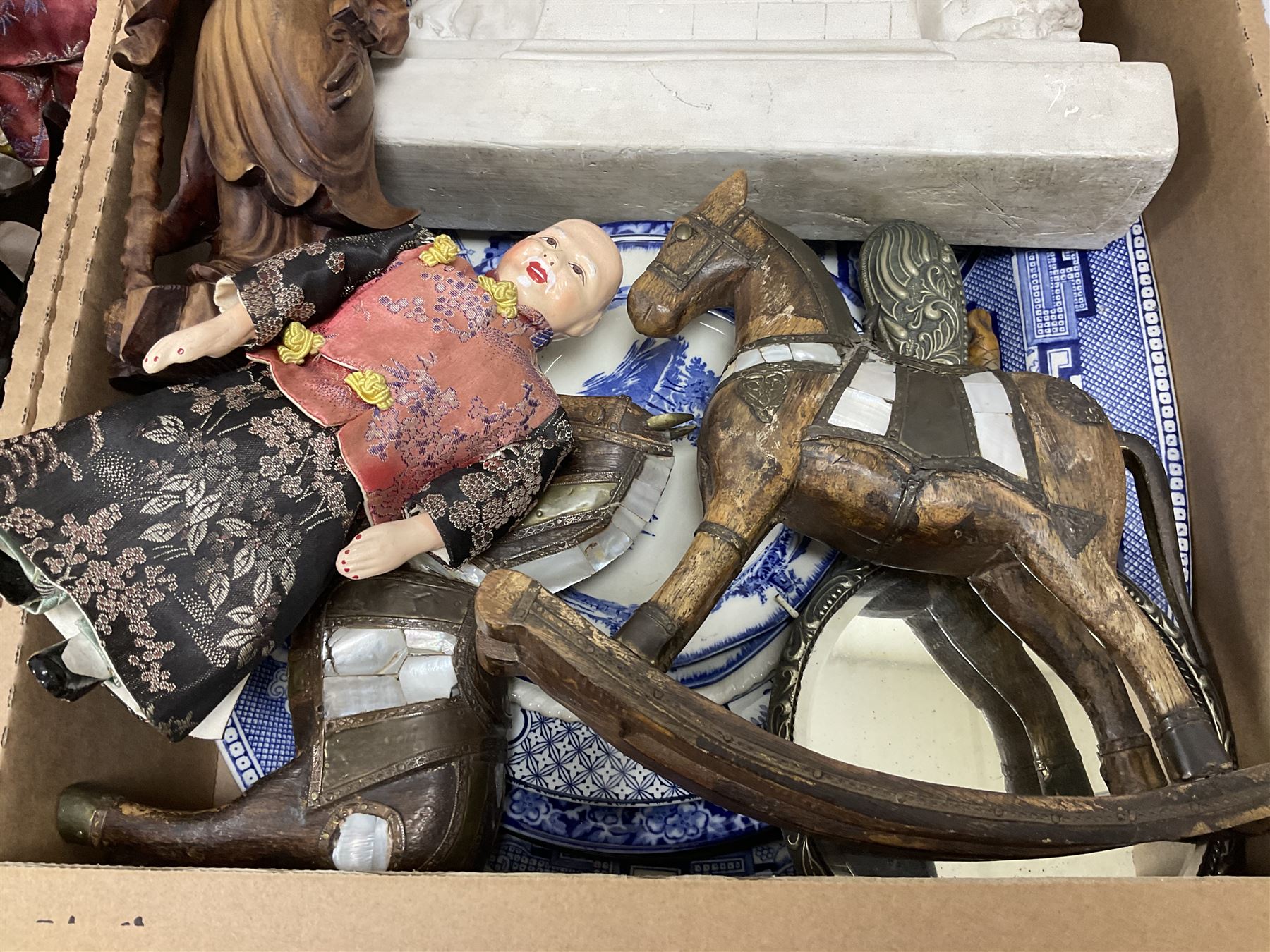 Collection of oriental dolls, cork display in glass case, carved wooden