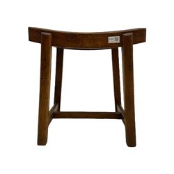 Early 20th century mahogany 'saddle' stool, removable cane seat