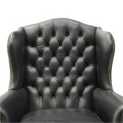 Pair of quality Georgian design wingback club armchairs, the high arched back with wings over rolled arms, upholstered in back-buttoned black leather with loose seat cushion, raised on foliate carved cabriole supports
