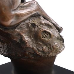 Bronze modelled as a cougar on a branch upon a rectangular wooden plinth, H24cm
