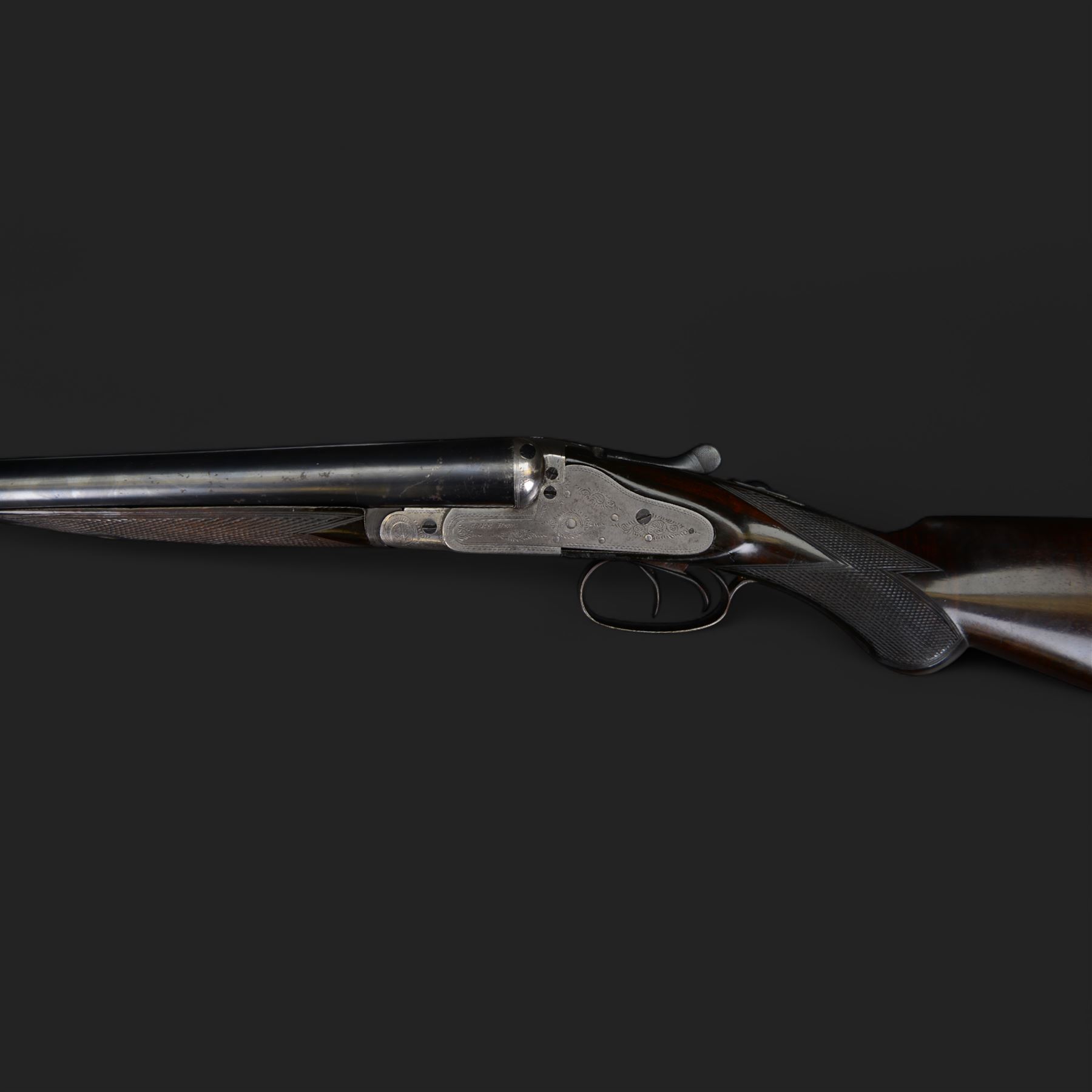 Carr Brothers of Huddersfield 12 bore side by side shotgun with engraved sidelock plates, trigger guard, underside, top plate, thumb lever and fences, chequered semi-pistol grip and horn tipped forend, vacant cartouche to the underside of the stock, double trigger and named 28 inch sleeved barrels choked ¾ and ½, overall length 113cm SHOTGUN CERTIFICATE REQUIRED