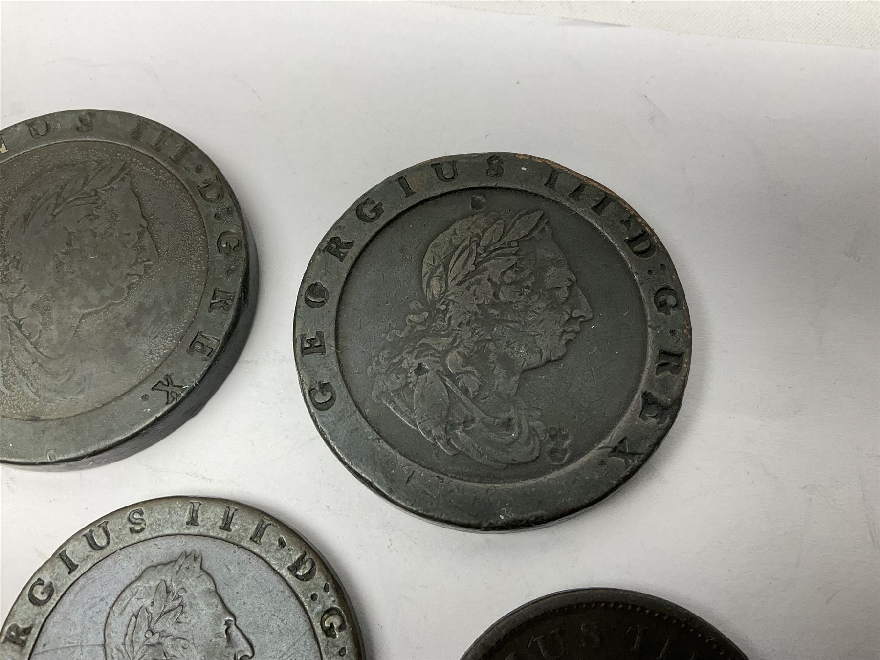 Two George III halfpenny coins dated 1799 and 1806, four pennies dated three 1806 and 1807, four 1797 cartwheel pennies and three 1797 cartwheel two pence coins