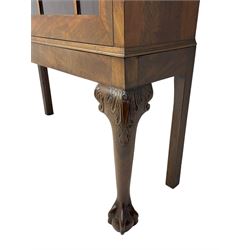 19th century figured mahogany bookcase, projecting dentil cornice over figured frieze, two astragal glazed doors enclosing four adjustable shelves, on acanthus carved cabriole supports with ball and claw feet