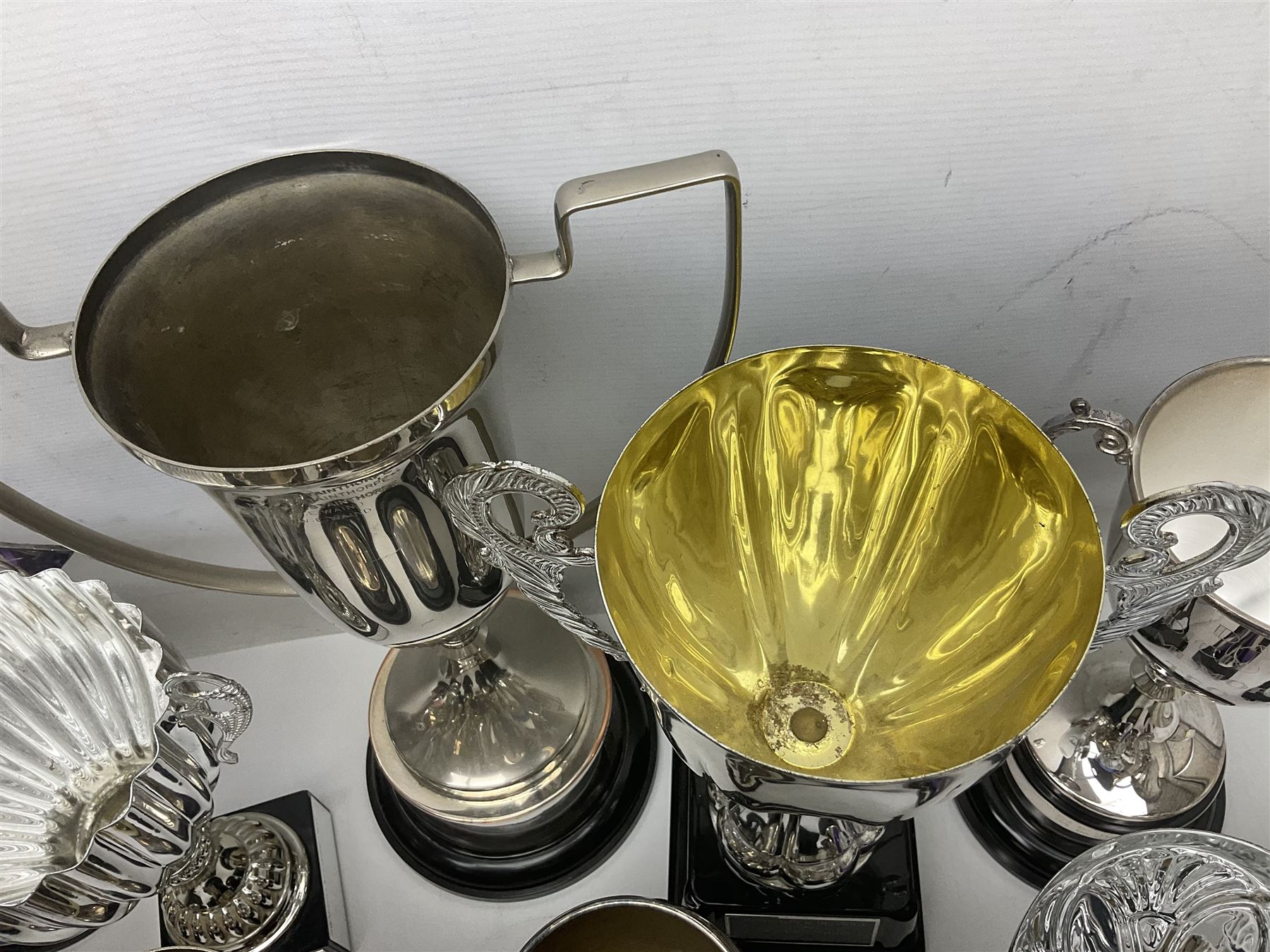 Collection of silver plated and metal trophy cups and winners plaques, all relating to the Burniston and District Show, most engraved with competitions and winner's names, in three boxes 