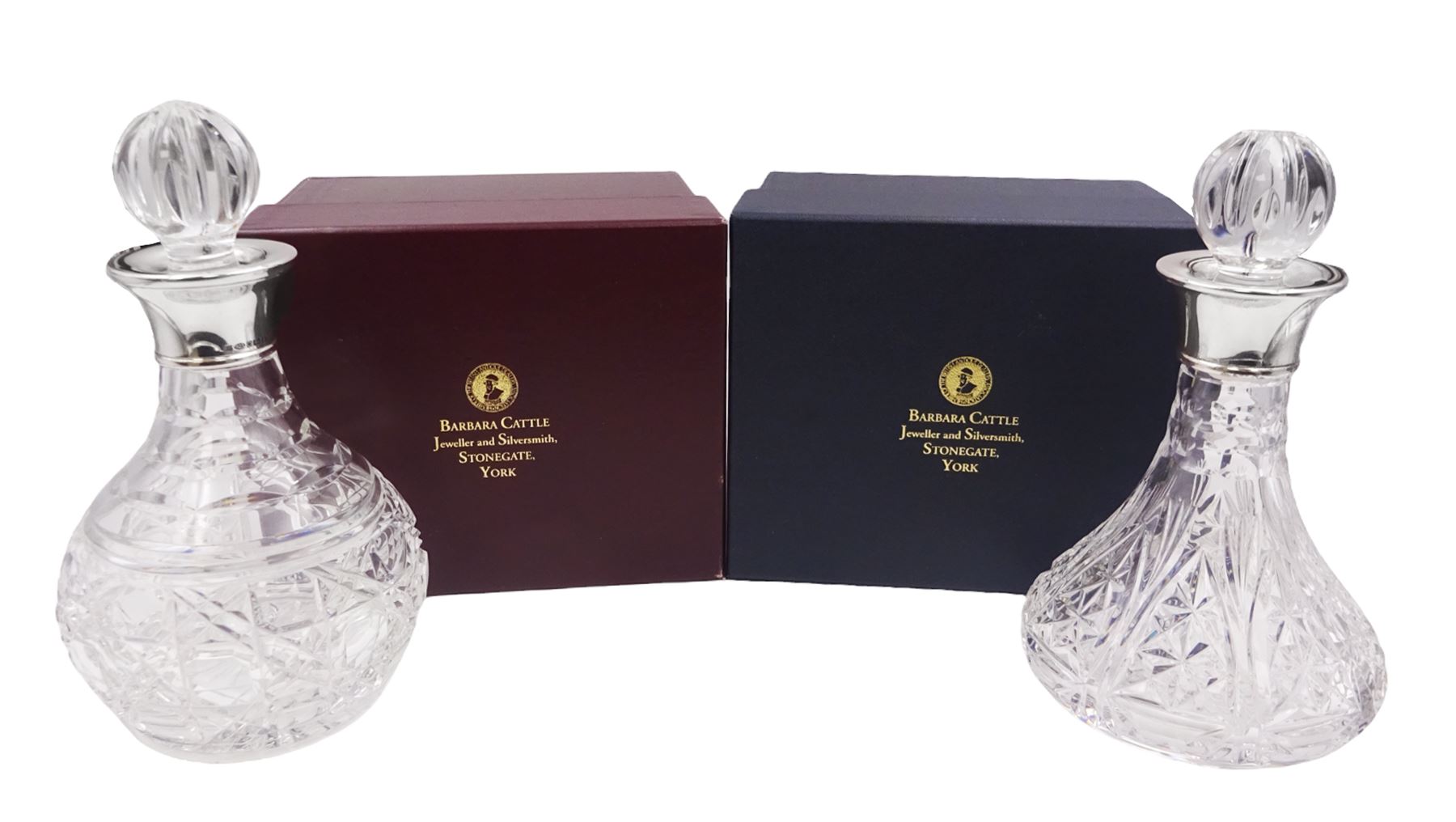 Two small modern silver mounted cut glass decanters, the first example of squat bulbous form, the body with navette, octagonal and hobnail cut decoration, with conforming stopper, the silver collar hallmarked Barker Ellis Silver Co, Sheffield 2005, H19cm, the second example, a ships decanter, with hobnail cut star decoration and conforming stopper, the silver collar hallmarked C J Vander Ltd, Sheffield 2005, H19cm, with boxes