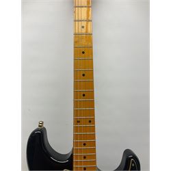 Copy of a Fender Stratocaster electric guitar in black with Wilkinson bridge, lock-in tuners, synchronised tremolo and various patent numbers; L99cm; in hard carrying case with strap and digital tuner